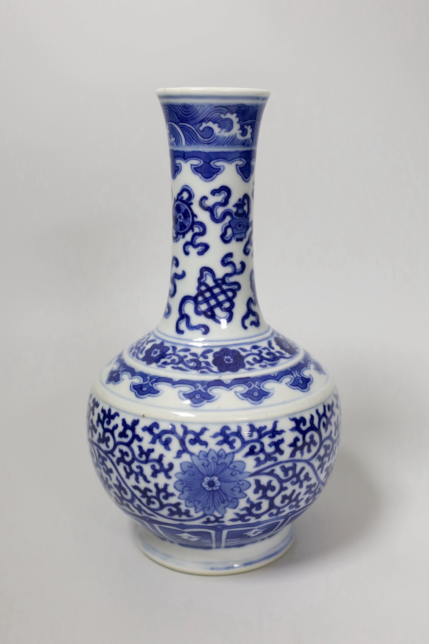 A late 19th century Chinese blue and white ‘eight Buddhist emblems’ vase, apocryphal Kangxi mark, 23cm